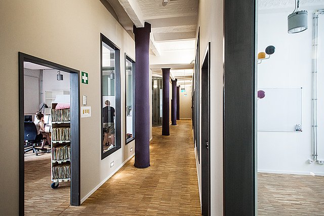 A bright uni-assist hallway with work colleagues.